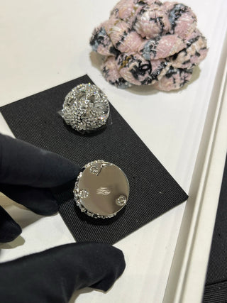 25A new style large silver stud earrings with full diamond embellishment,  镂空 (hollowed-out) design, and star and ball motifs.