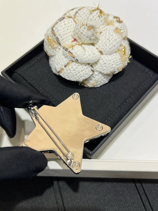 25A new arrival: Silver brooch with full crystal embellishment, featuring a double C logo and a hollowed-out star design.