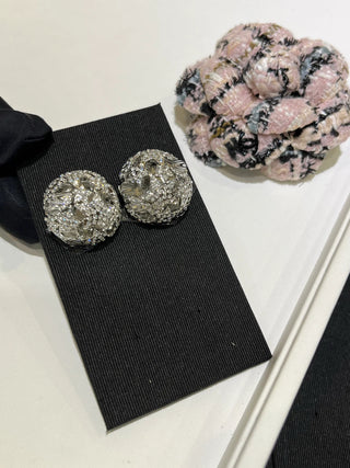 25A new style large silver stud earrings with full diamond embellishment,  镂空 (hollowed-out) design, and star and ball motifs.