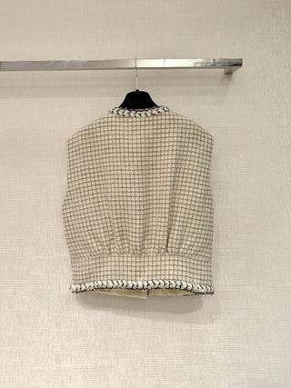 Chane* 25K lace vest features classic tweed trim with delicate chain lace accents and a silk lining.