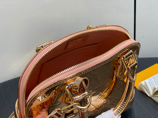 Small gold-plated patent leather shell bag