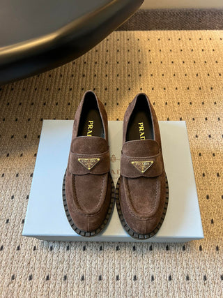 Prad classic loafers with triangular logo and serrated design.