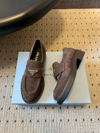 Prad classic loafers with triangular logo and serrated design.