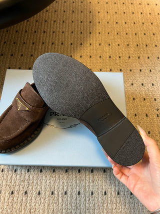 Prad classic loafers with triangular logo and serrated design.