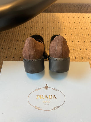 Prad classic loafers with triangular logo and serrated design.
