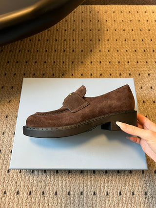 Prad classic loafers with triangular logo and serrated design.