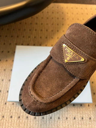 Prad classic loafers with triangular logo and serrated design.
