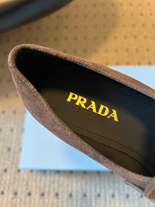 Prad classic loafers with triangular logo and serrated design.