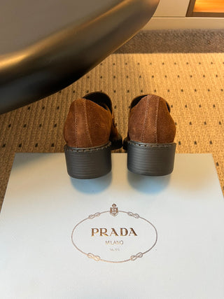 Prad classic loafers with triangular logo and serrated design.