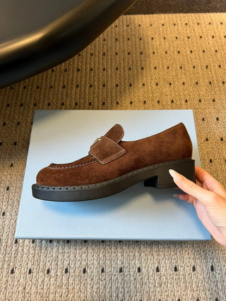 Prad classic loafers with triangular logo and serrated design.