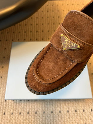 Prad classic loafers with triangular logo and serrated design.