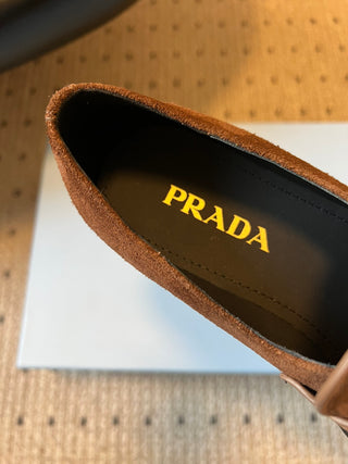 Prad classic loafers with triangular logo and serrated design.