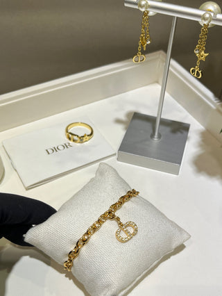 𝐃𝐢𝐨 * 25-year-old, fully encrusted CD pendant in champagne gold with a bracelet.