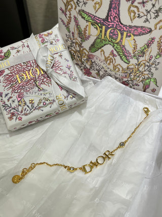 Dio*’s new gold-lettered crystal bracelet.