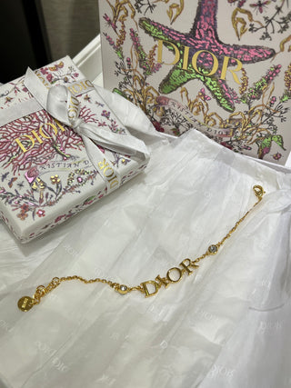 Dio*’s new gold-lettered crystal bracelet.