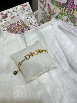 Dio*’s new gold-lettered crystal bracelet.
