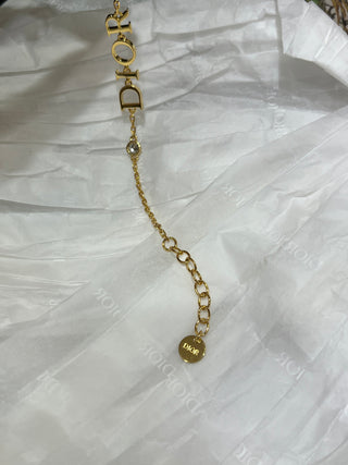 Dio*’s new gold-lettered crystal bracelet.