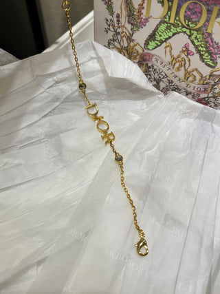 Dio*’s new gold-lettered crystal bracelet.